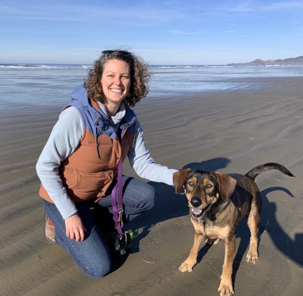 katie and a dog at the beach