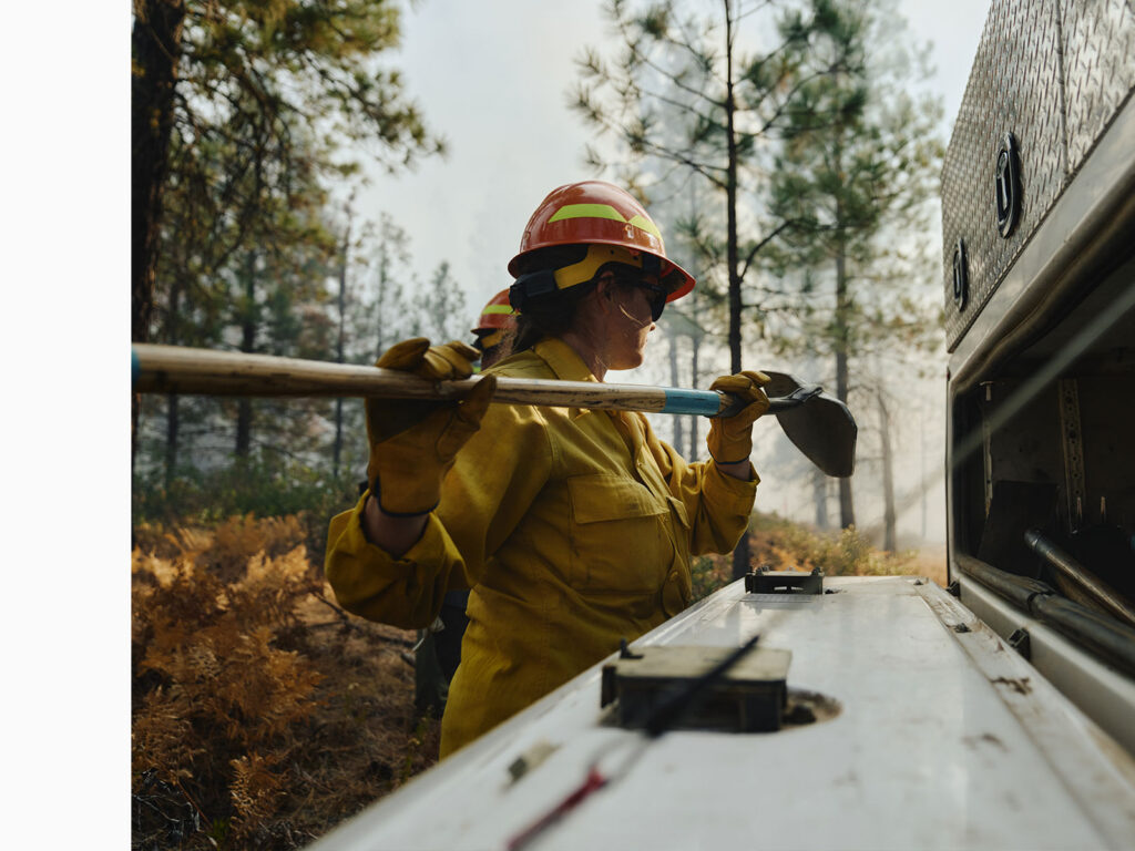 Person removing a tool from a truck during a controlled burn in Washington